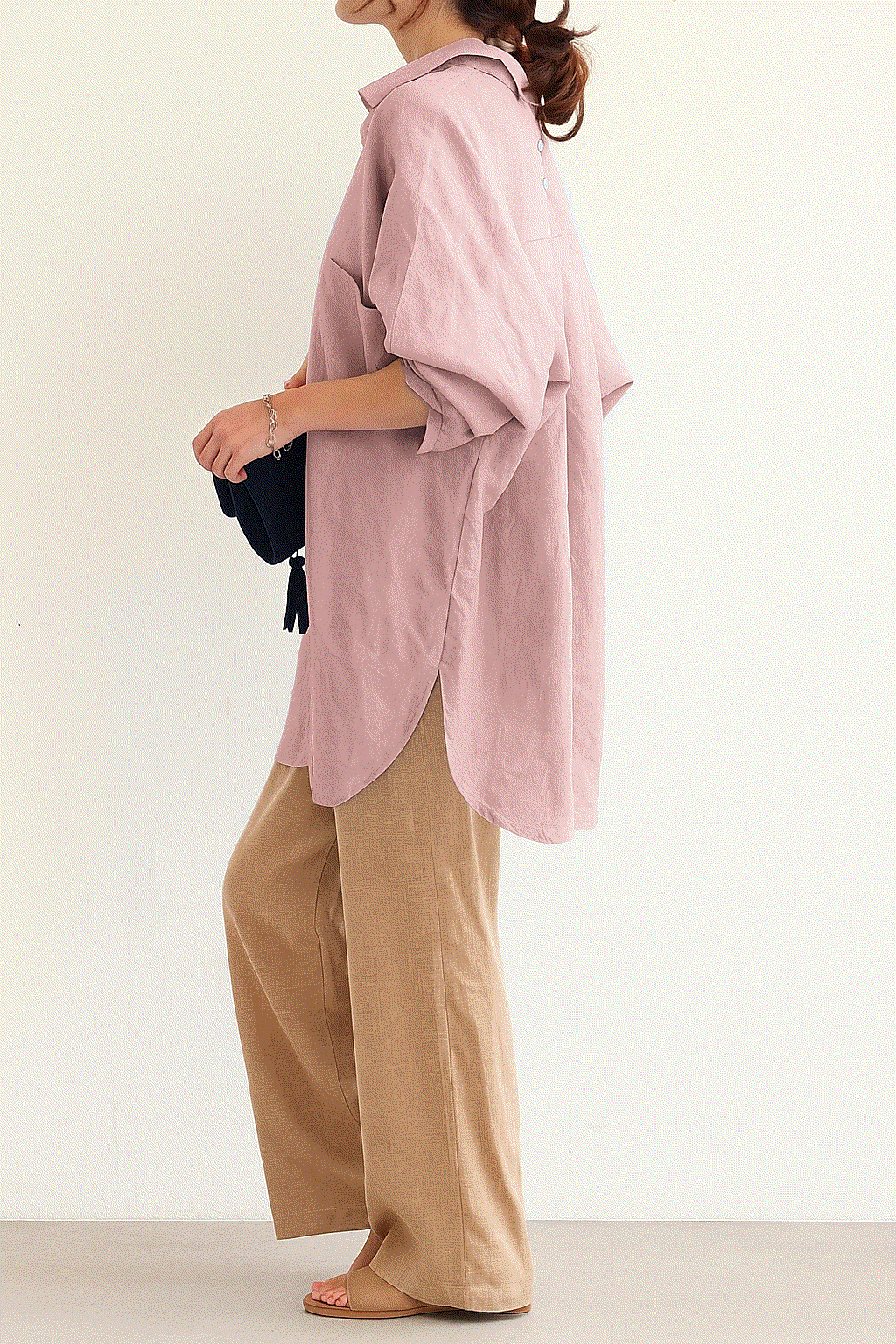 Woman wearing Linen Breeze Set with a pink oversized linen-cotton shirt and beige high-waist palazzo pants.