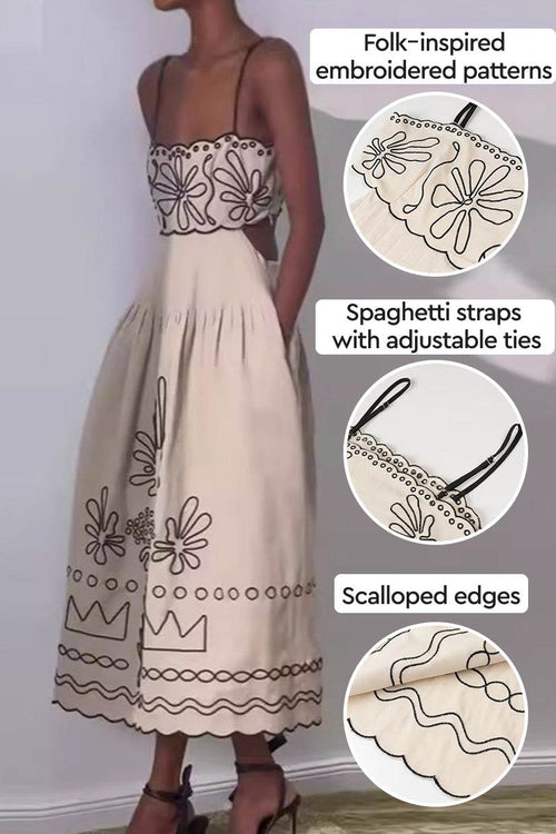 Artisan embroidered beige bohemian maxi dress with folk-inspired floral patterns, adjustable spaghetti straps, and scalloped edges.
