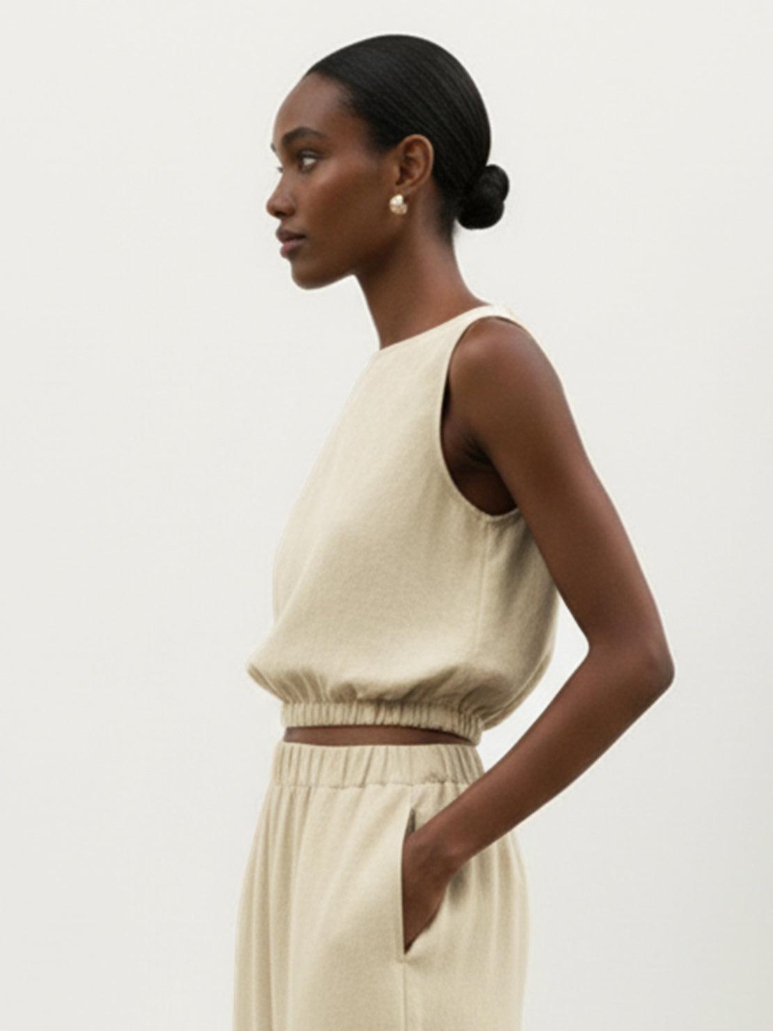 Lightweight linen-blend set with sleeveless top and wide-leg pants featuring elastic waistband and side slits for comfort and airflow