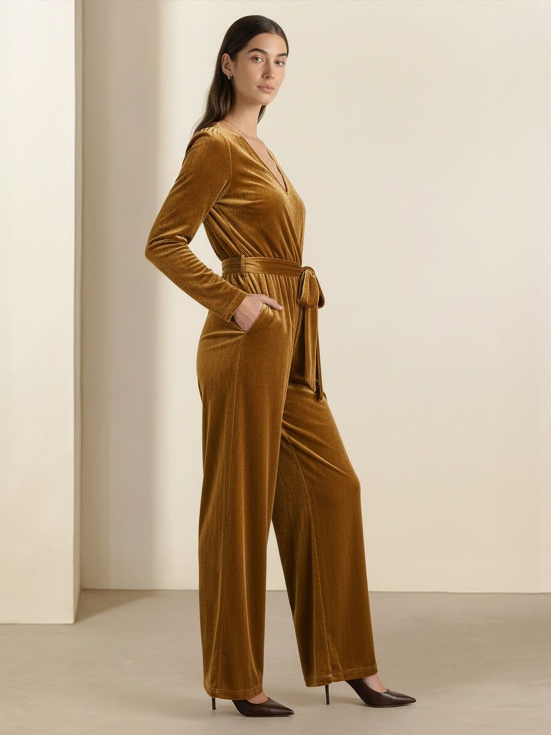 Woman wearing a deep V-neck velvet suit with long sleeves and wide-leg pants