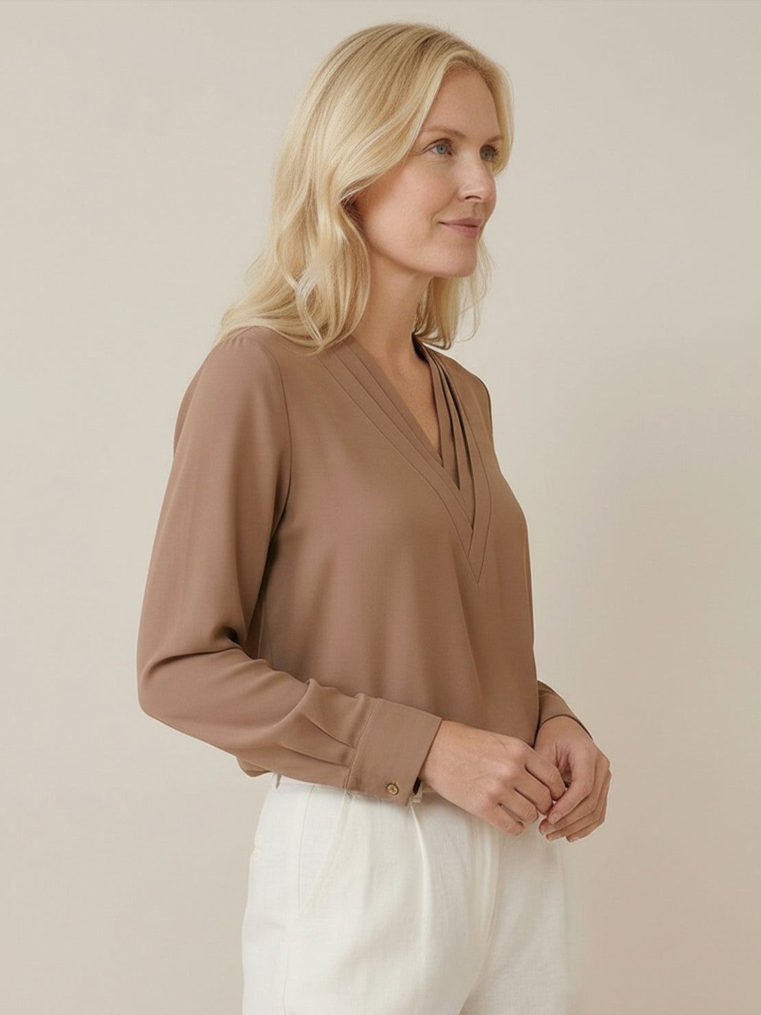 White pleated V-neck long-sleeve blouse with button cuffs and relaxed fit