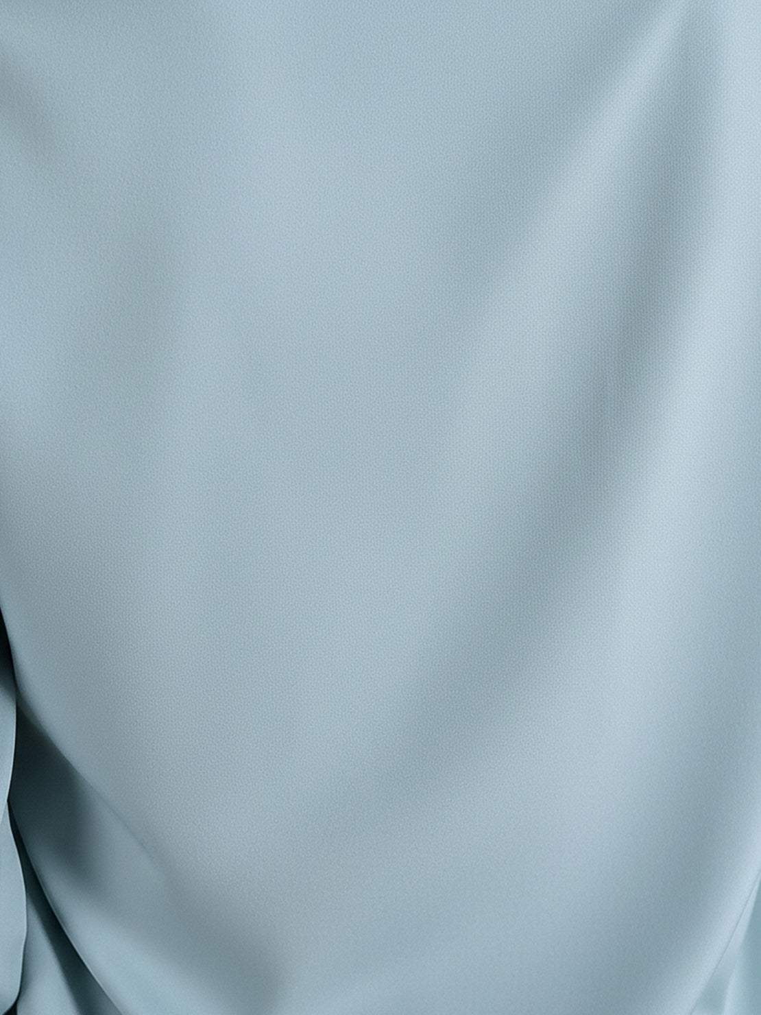 White pleated V-neck long-sleeve blouse with diagonal pleated detail and button cuffs