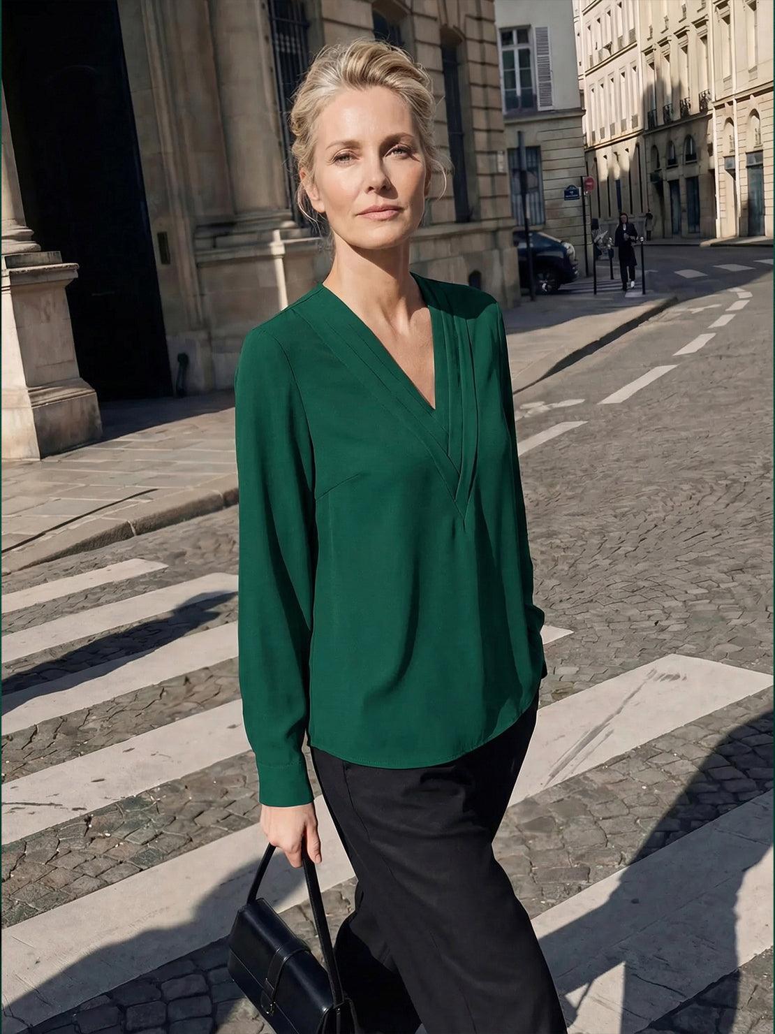 White pleated V-neck long-sleeve blouse with diagonal pleated panel and button cuffs