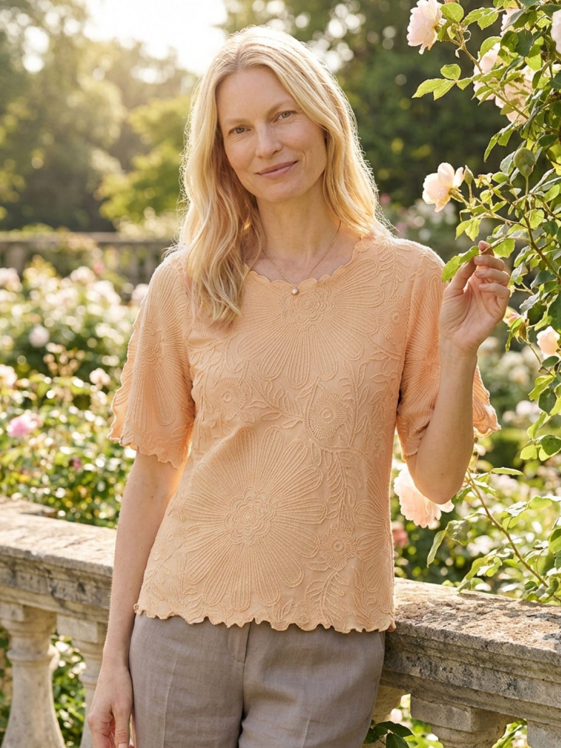 Floral jacquard pleated top with 3D floral texture, flutter sleeves, and relaxed A-line silhouette