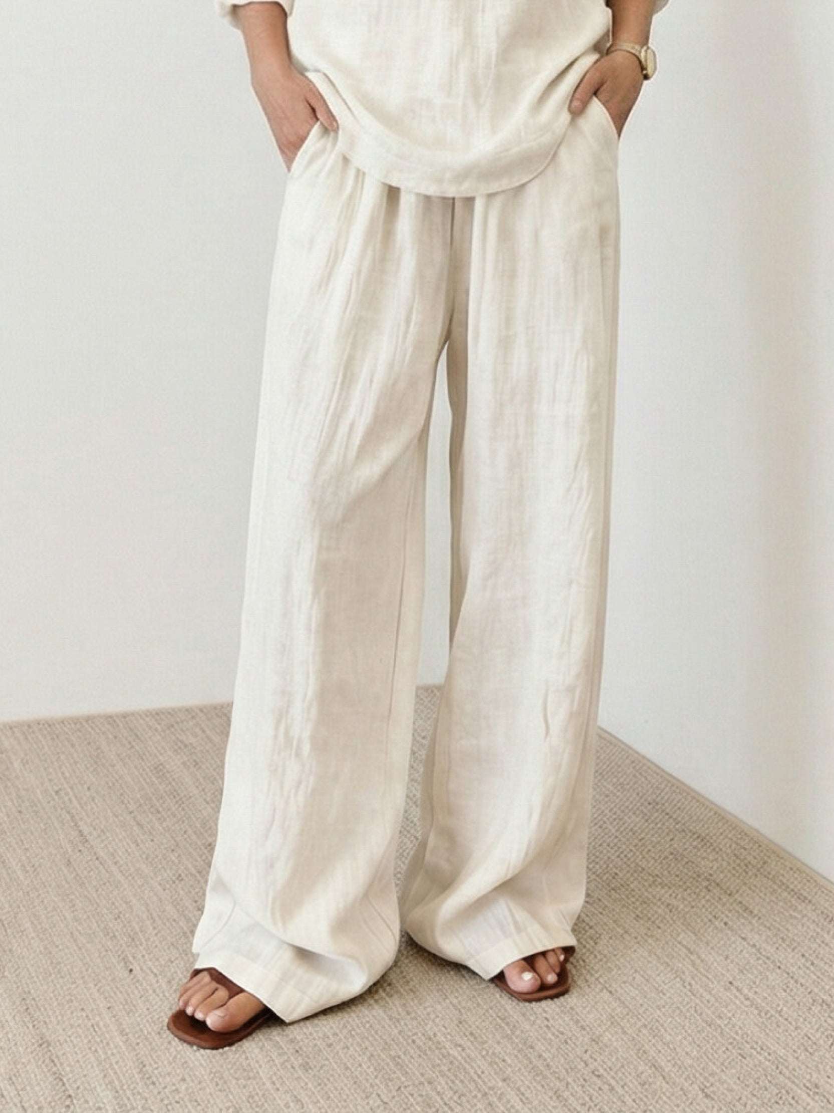Woman wearing 100% cotton linen set with V-neck top and wide-leg pants