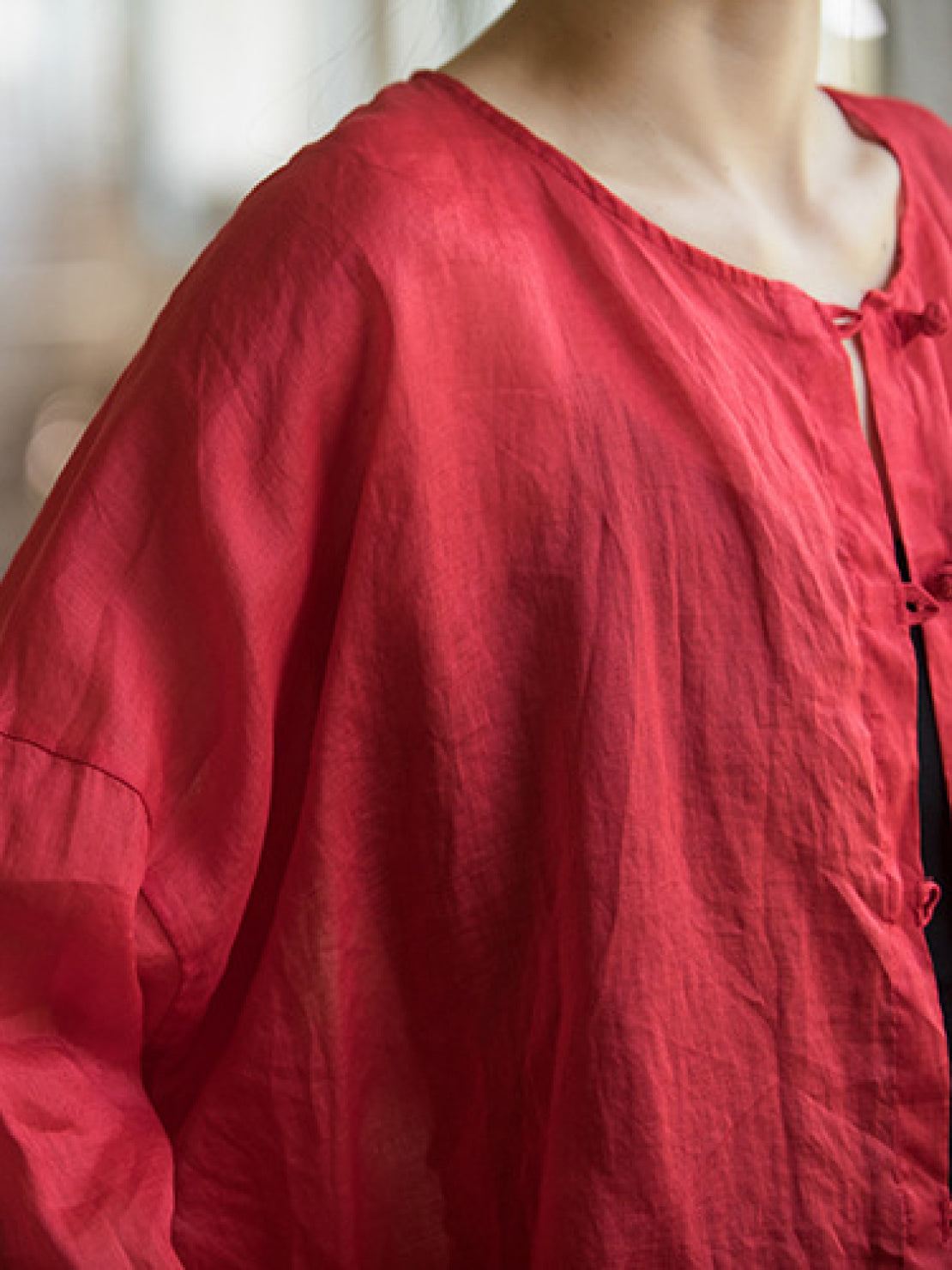 Oversized 100% linen blouse with frog-button closure and curved hem in lightweight semi-sheer fabric