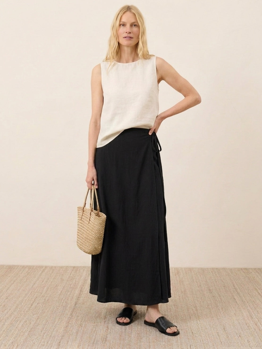 woman wearing asymmetrical wrap maxi skirt with side tie closure and flowing fabric