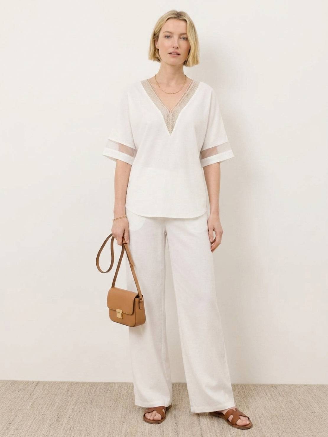 Mature woman wearing a lightweight linen top with short sleeves and three-button front detail