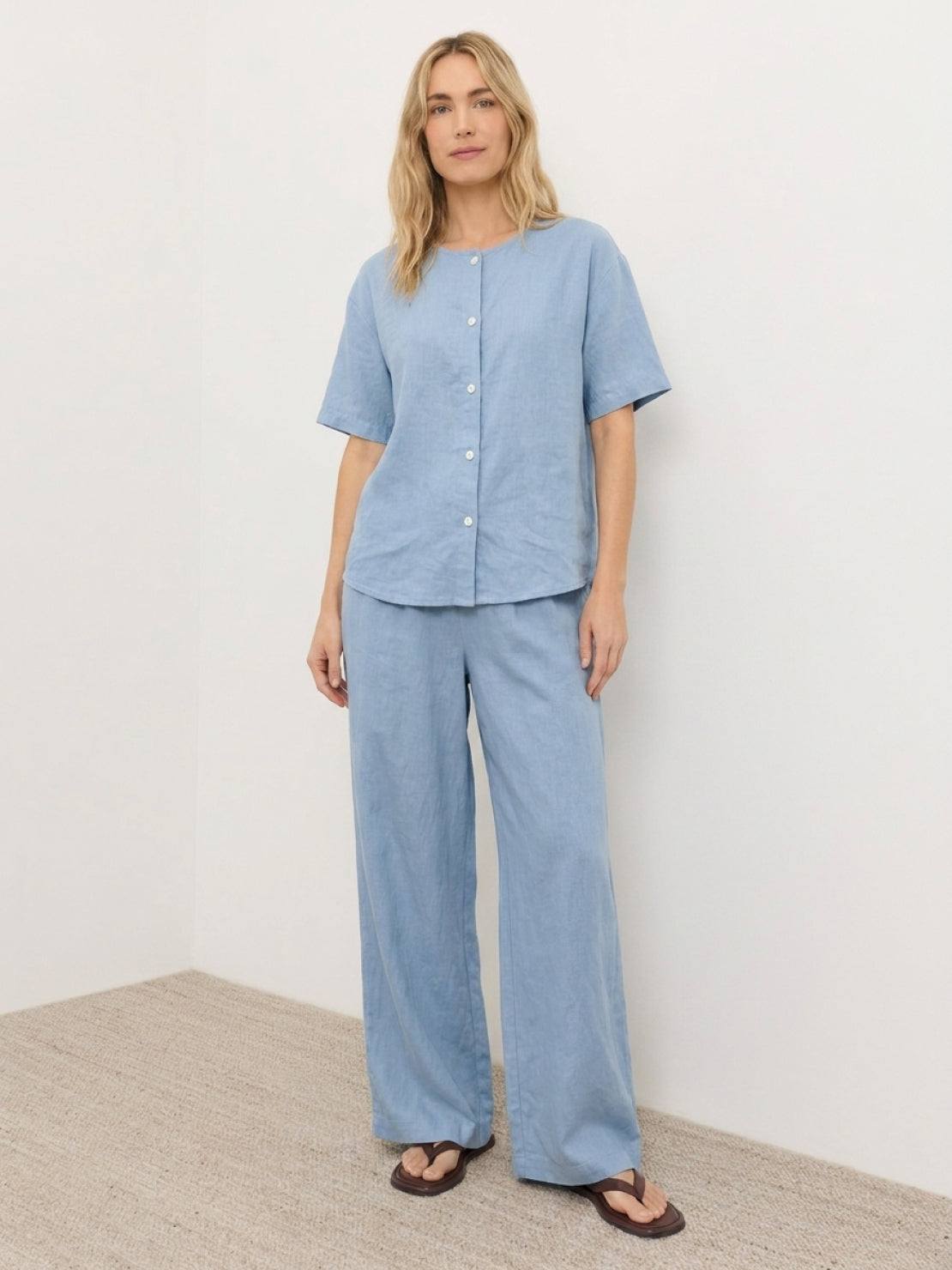 woman wearing 100% cotton navy blue two-piece set with button-front top and wide-leg pants
