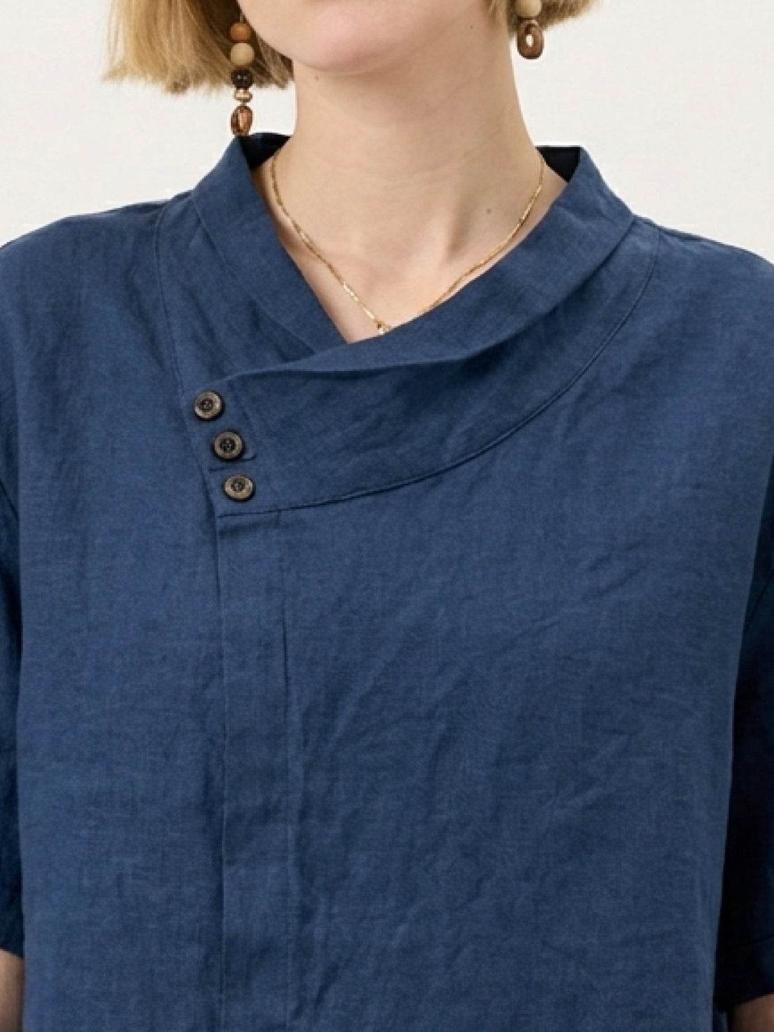 woman wearing 100% linen relaxed V-neck top with asymmetric button detail in navy blue