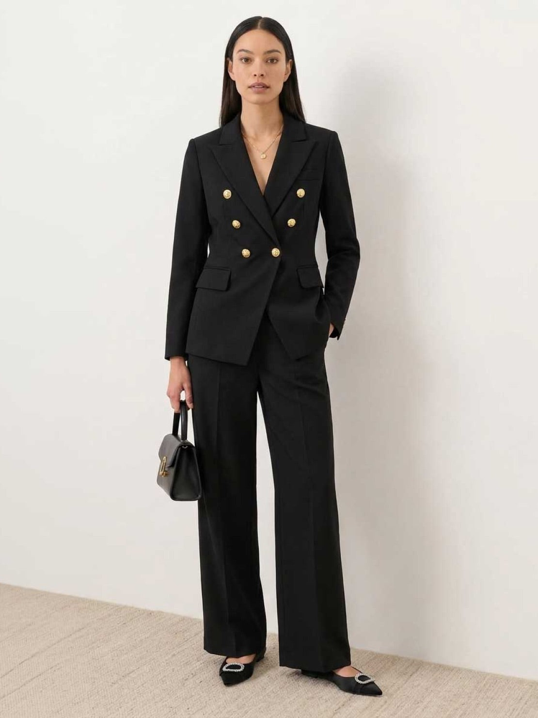 Woman wearing gold button double-breasted blazer with wide-leg trousers co-ord set