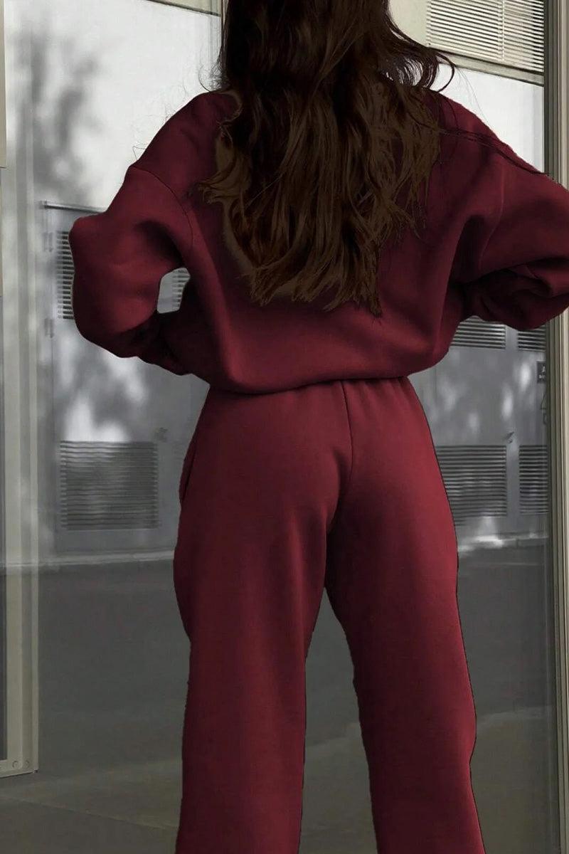 woman wearing cotton-blended two-piece tracksuit with high collar and zipper standing outdoors