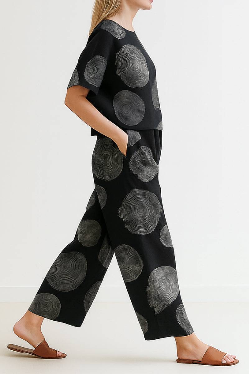 Woman wearing Breezy Meadow Two-Piece Set with relaxed top and wide-leg trousers in lightweight fabric