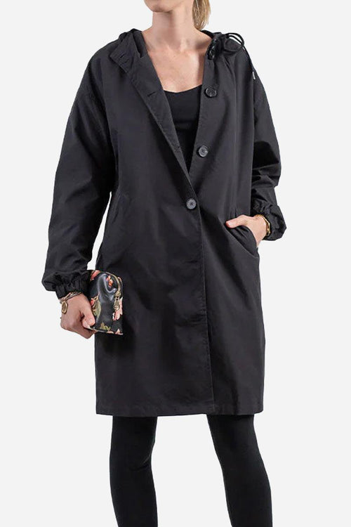 Black oversized water-resistant windbreaker with hood and buttons, worn by model