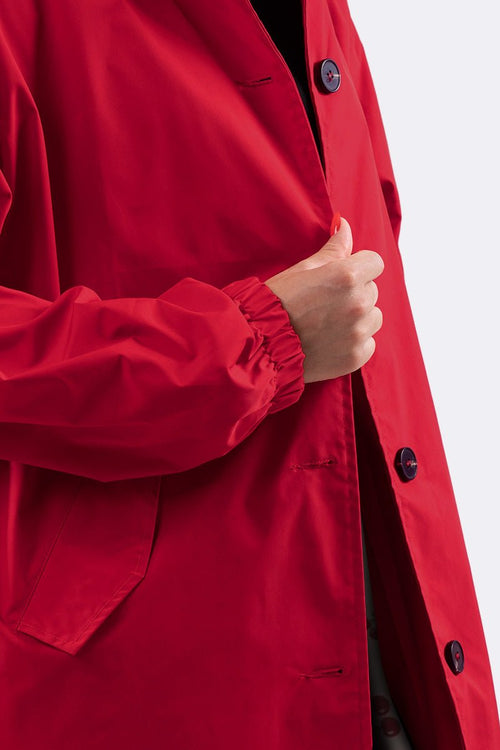 Water-resistant oversized windbreaker jacket in red with button closure and elastic cuffs