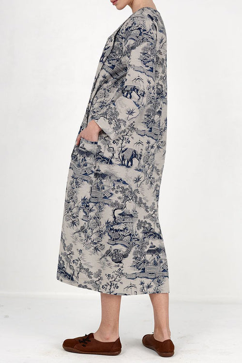 Side view of a woman wearing a Japanese Porcelain Print midi dress with 3/4 sleeves and oversized pockets in cozy blue patterned fabric