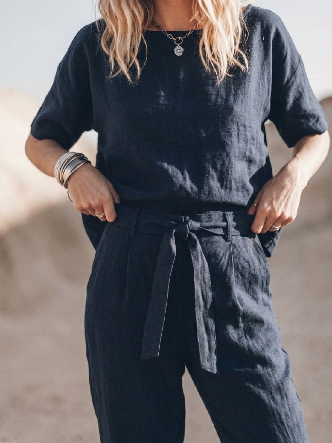 woman wearing relaxed fit cotton linen set with short sleeve top and straight leg pants in monochrome tones