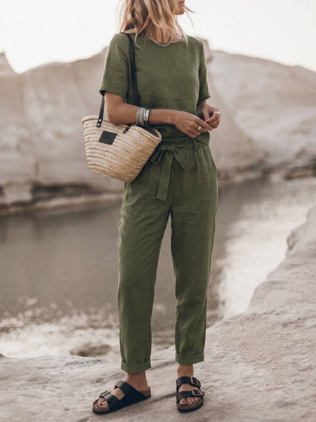 Woman wearing a relaxed cotton linen set with short-sleeve top and straight-leg pants in monochrome tones