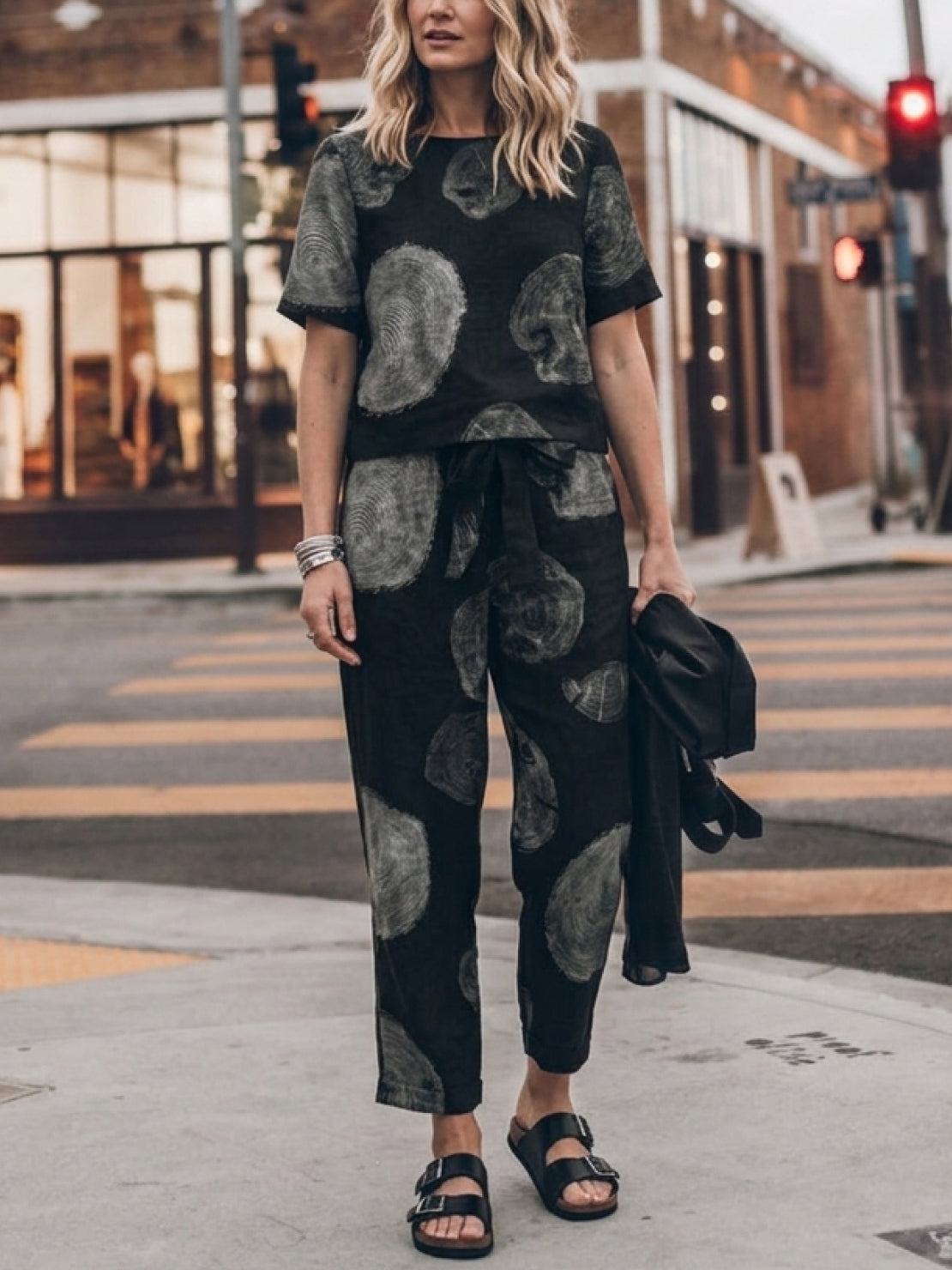 woman wearing relaxed cotton linen set with short sleeve top and straight-leg pants in neutral tones