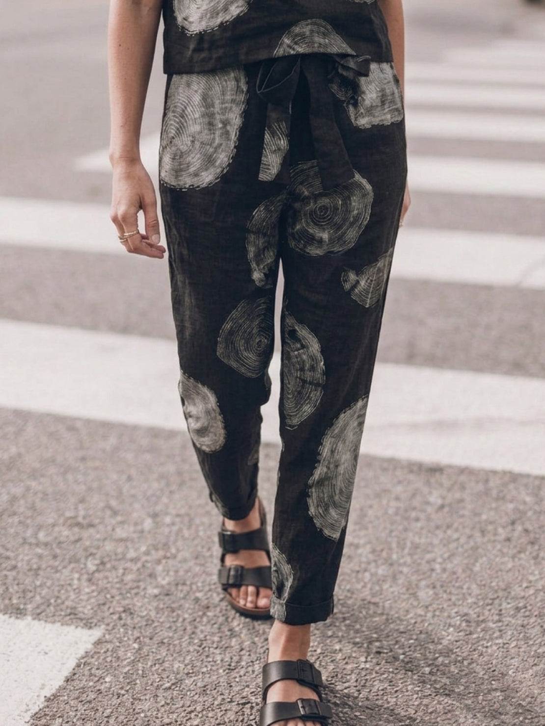 Woman wearing a breathable cotton linen set with relaxed short-sleeve top and straight-leg pants in monochrome tones
