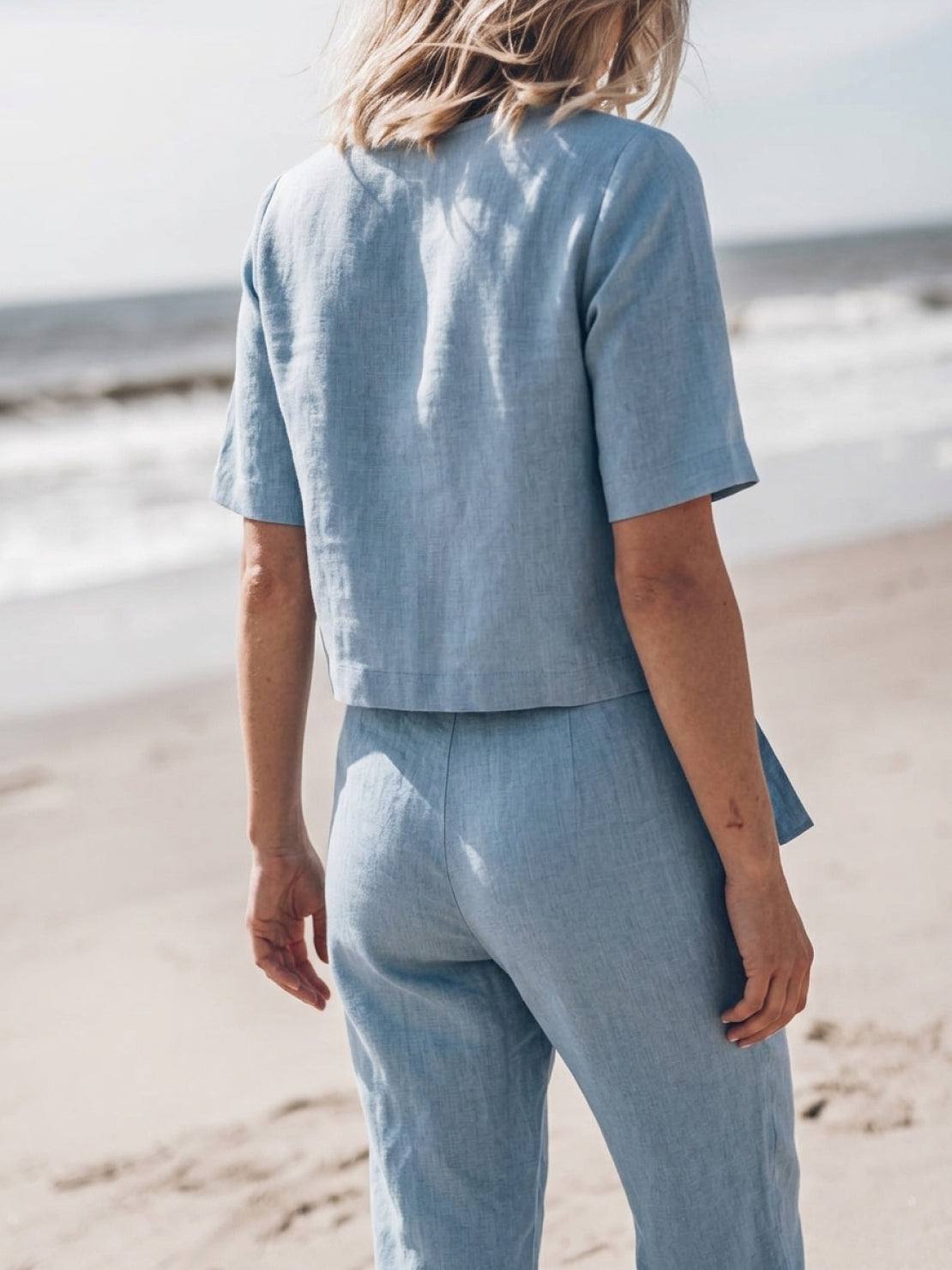 woman wearing breathable cotton linen set with short-sleeve top and straight-leg pants in monochrome tones