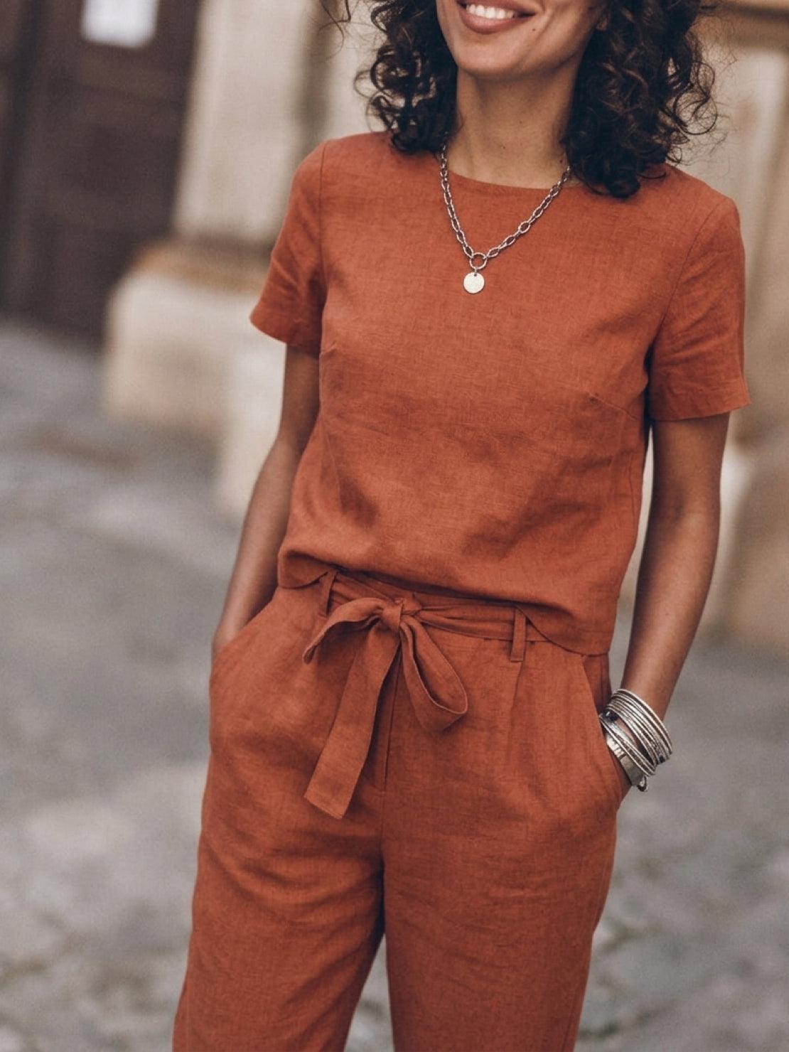 Woman wearing relaxed cotton linen set with short-sleeve top and straight-leg pants in monochrome tones
