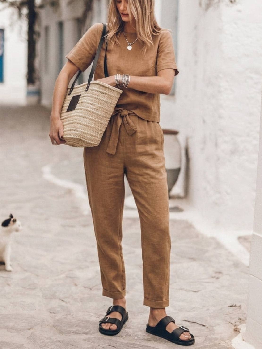 Woman wearing breathable cotton linen set with relaxed short-sleeve top and straight-leg pants in monochrome tones
