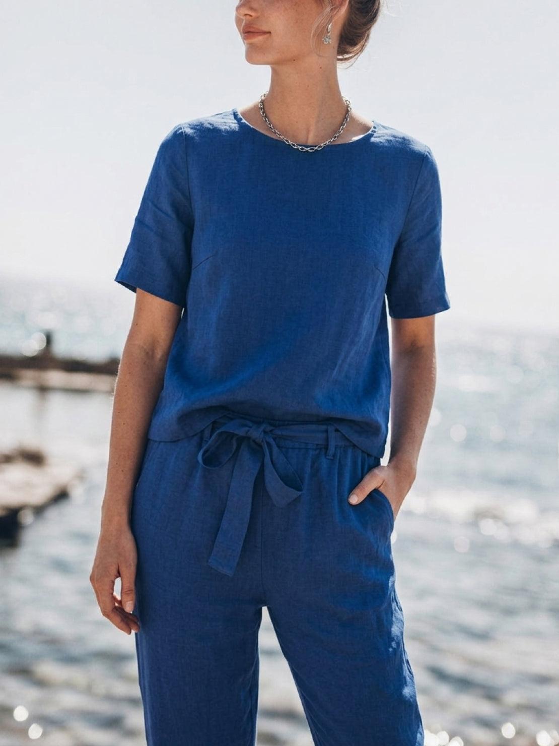 Woman wearing a relaxed cotton linen set with short-sleeve top and straight-leg pants in monochrome tones