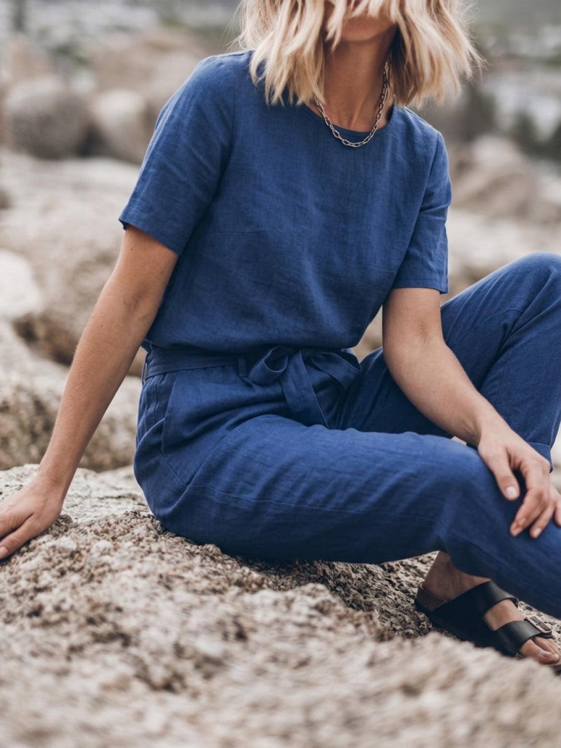 Woman wearing a relaxed fit cotton linen set with short sleeve top and straight-leg pants in monochrome tones