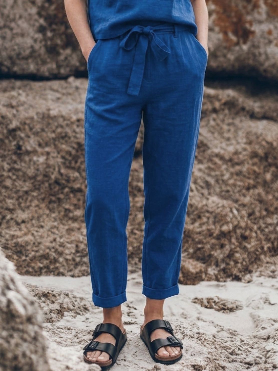 Model wearing relaxed cotton linen set with short-sleeve top and straight-leg pants in monochrome tones
