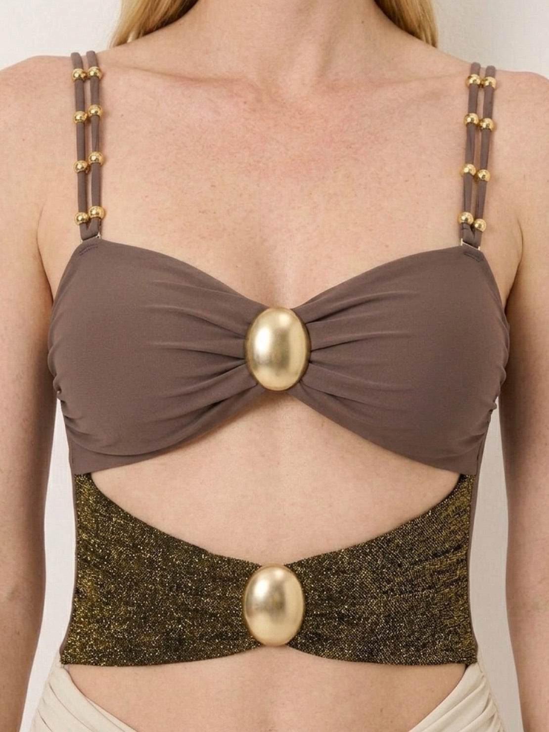 Gold-detail cutout one-piece swimsuit with ruched panels and midi wrap skirt on white background