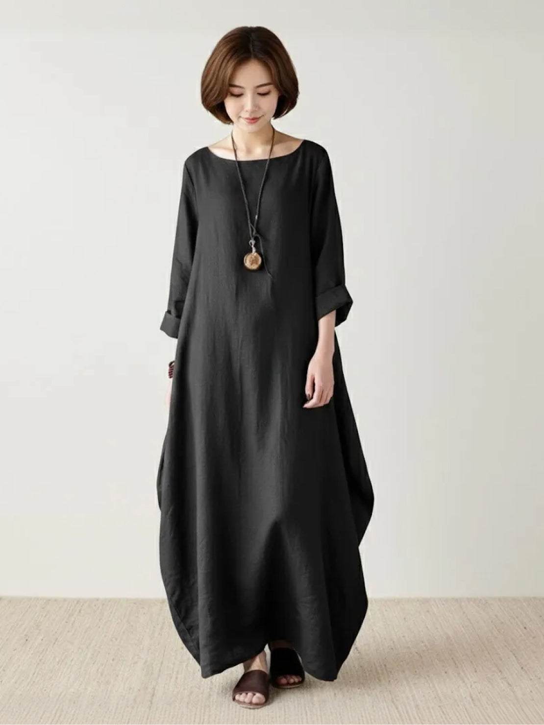 Bohemian maxi dress in loose fit linen blend with long sleeves and floor-length hem.