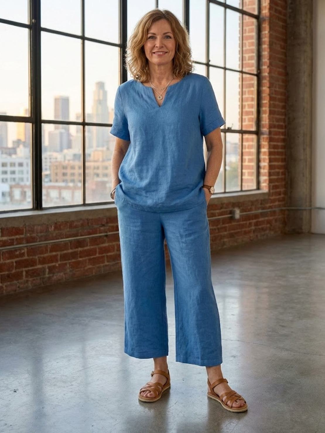 Woman wearing breezy cotton blend two-piece summer set with short-sleeve shirt and elastic waist pants
