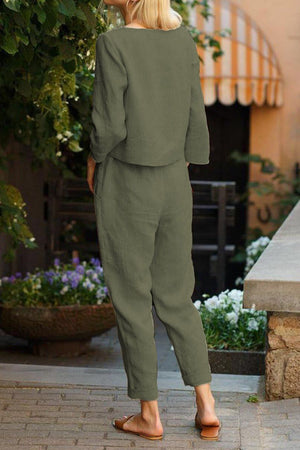 Back view of woman wearing relaxed cotton-linen monochrome capsule outfit with longline top and wide-leg pants in olive green.