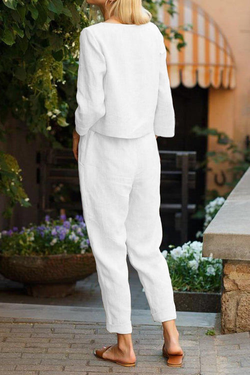 Woman wearing white Cotton-Linen Monochrome Capsule set with relaxed longline top and wide-leg pants outdoors