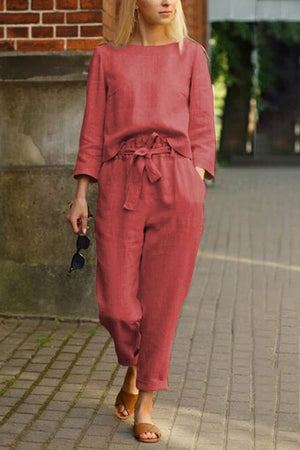 Woman wearing relaxed fit red cotton-linen monochrome capsule set with longline top and wide-leg pants walking outdoors
