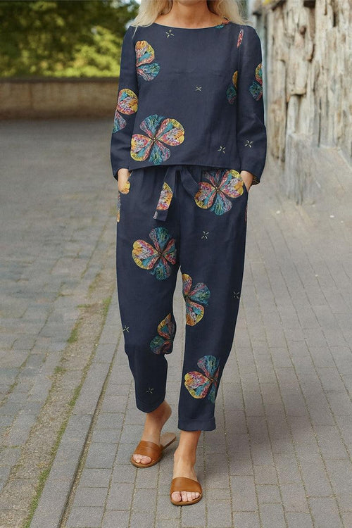 woman wearing dark cotton-linen monochrome set with colorful floral prints and relaxed fit walking outdoors