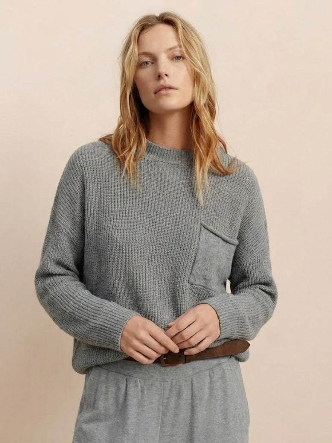 European minimalist relaxed gray knit sweater top with pocket detail paired with matching trousers