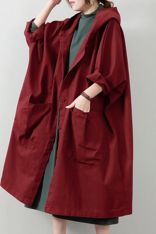 Oversized one-size water-resistant windbreaker jacket with hood and large pockets in deep red color, featuring a waterproof design.