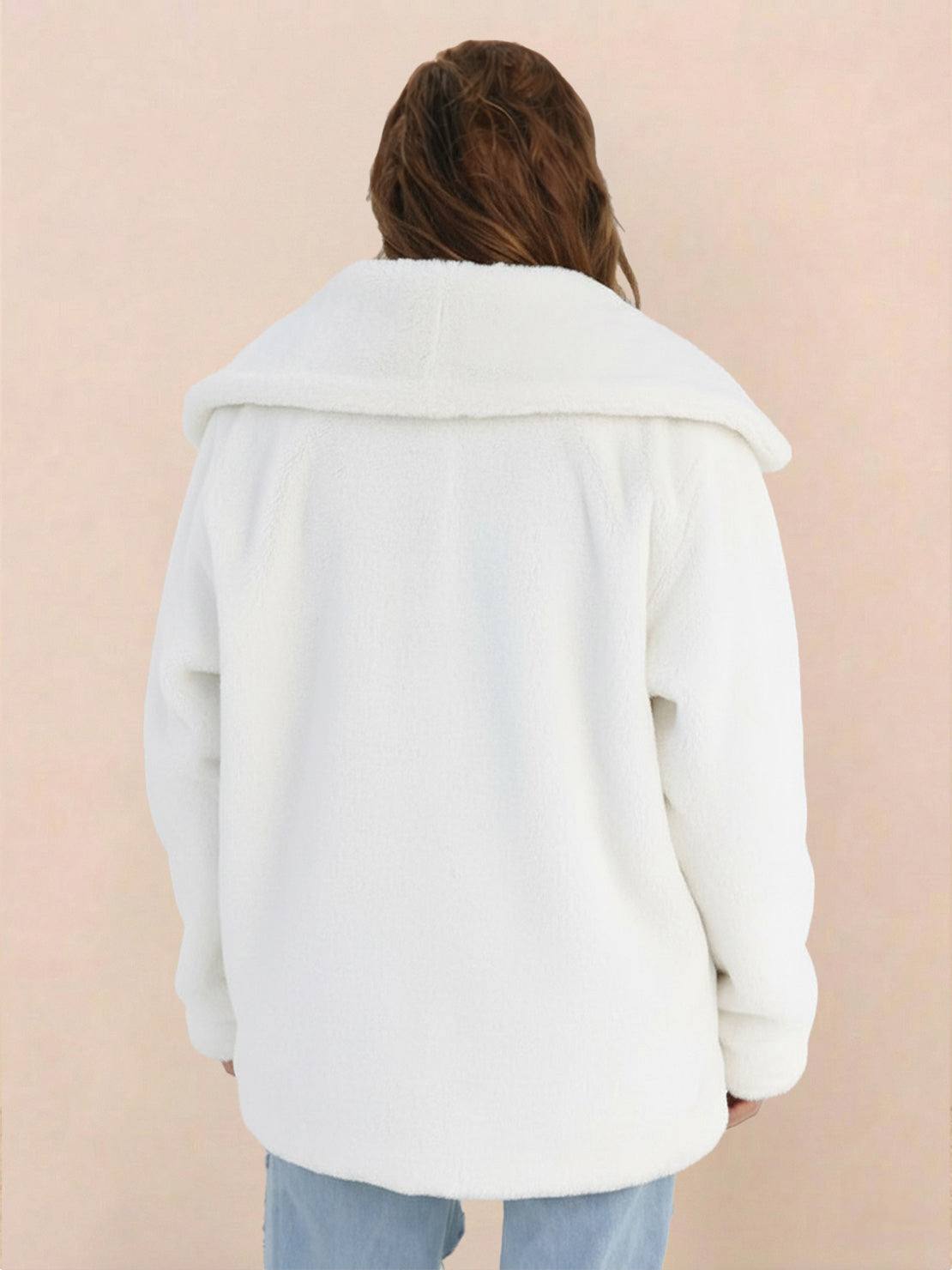 Back view of a white open front oversized faux fur jacket with a draped shawl collar worn by a model