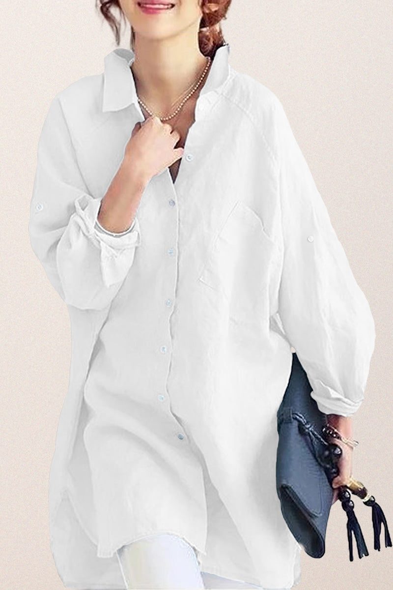 White oversized linen shirt with relaxed fit and button details worn by woman holding a clutch