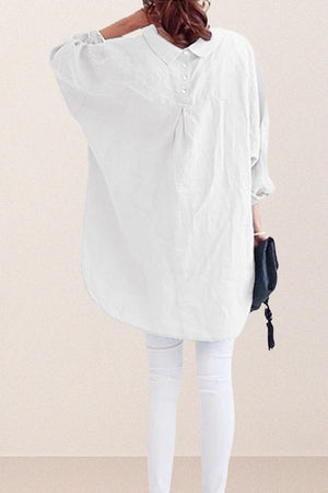 Back view of a woman wearing an oversized white linen and cotton blend shirt with relaxed fit and gathered back detailing
