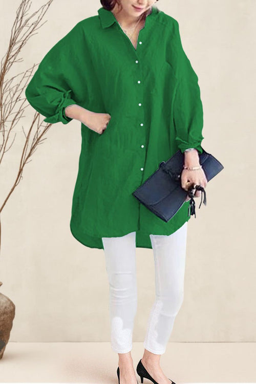 Oversized linen shirt in green with button-up front and long sleeves styled with white pants and black heels