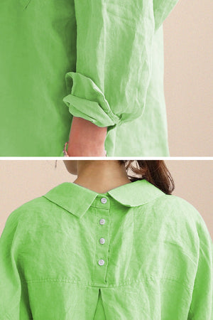 Close-up of a bright green oversized linen shirt with rolled sleeves and button details on the back yoke