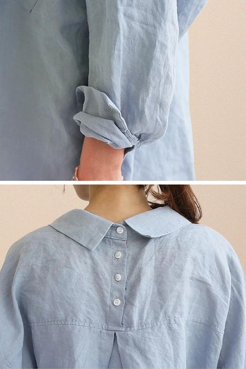 Light blue oversized linen shirt with rolled-up sleeves and buttoned back detailing