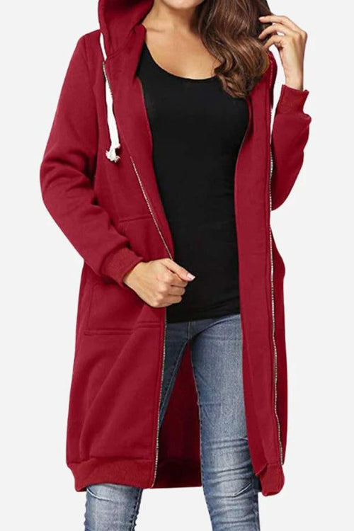 woman wearing oversized long zip sweatshirt hoodie in burgundy with drawstring hood and front pockets