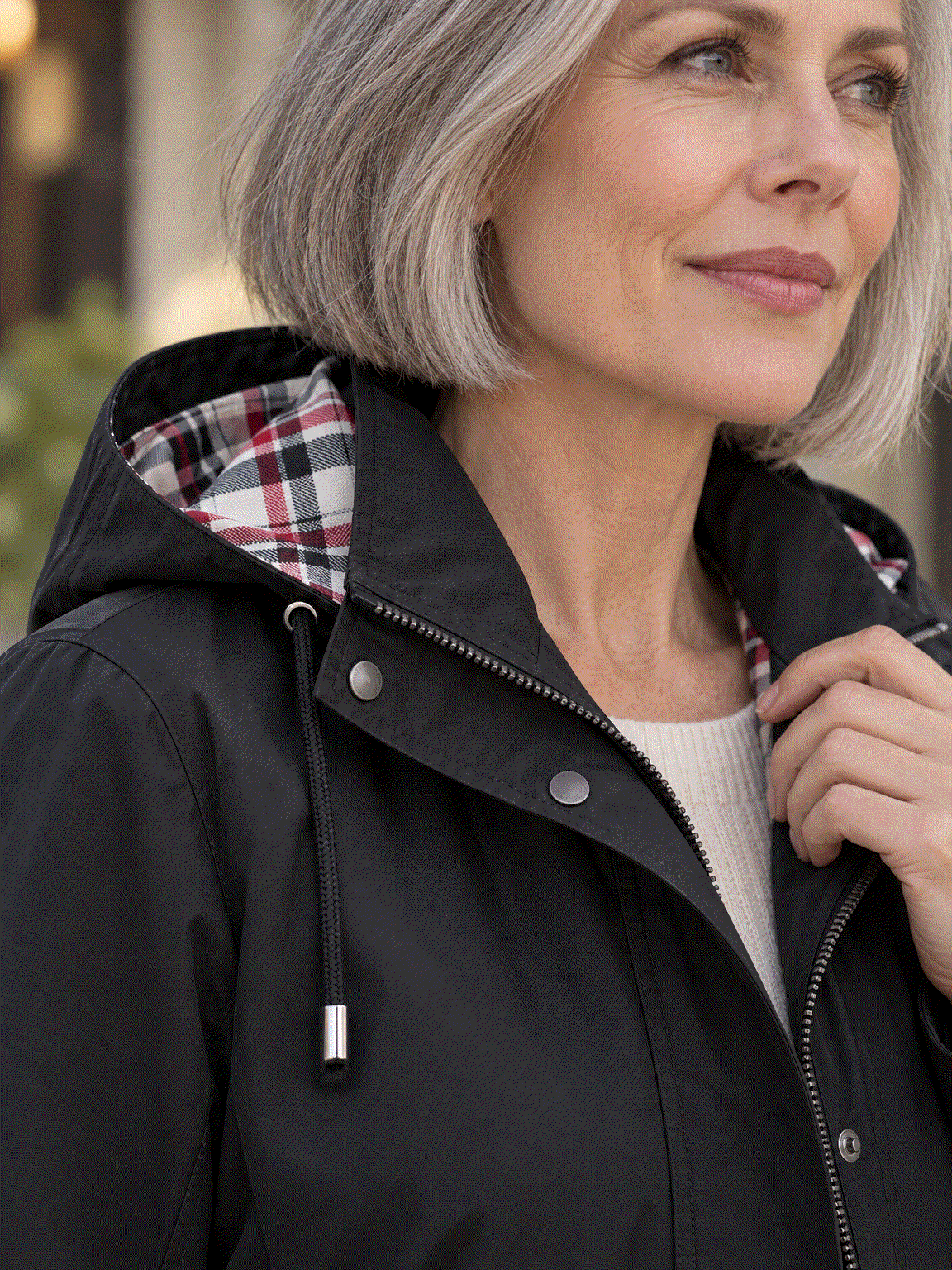 Plaid-lined hooded waterproof rain jacket with adjustable drawstring waist and snap flap pockets