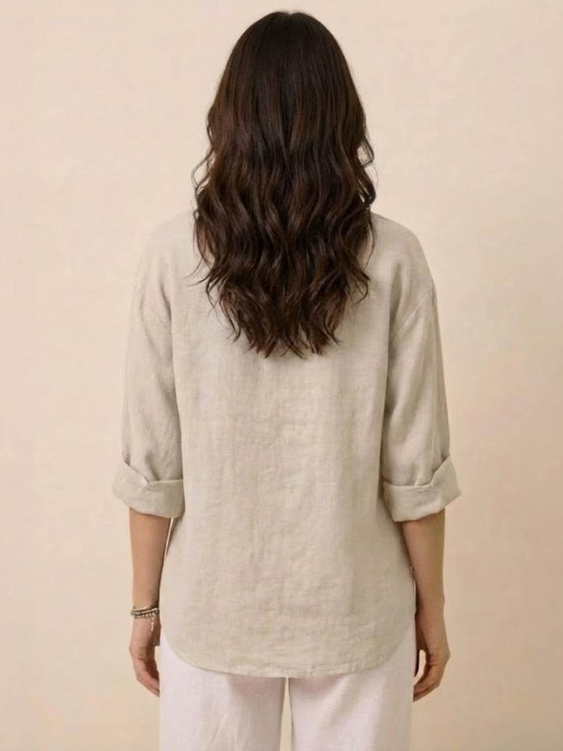 White pure linen age-defying shirt with button detail on hanger
