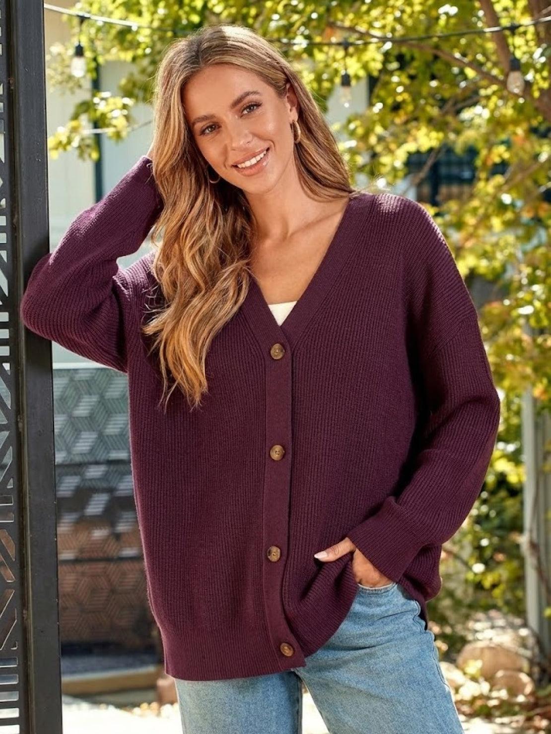 Relaxed fit oversized button down knitwear cardigan in deep purple on smiling woman outdoors