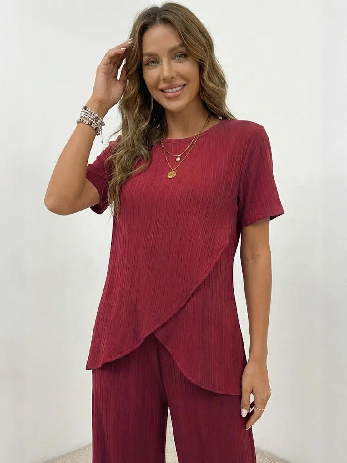 Woman wearing textured elegance two-piece set with asymmetrical top and wide-leg pants in soft stretch fabric